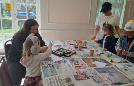 Children Painting on Heart Shaped Pieces of Paper Children Painting on Heart Shaped Pieces of Paper