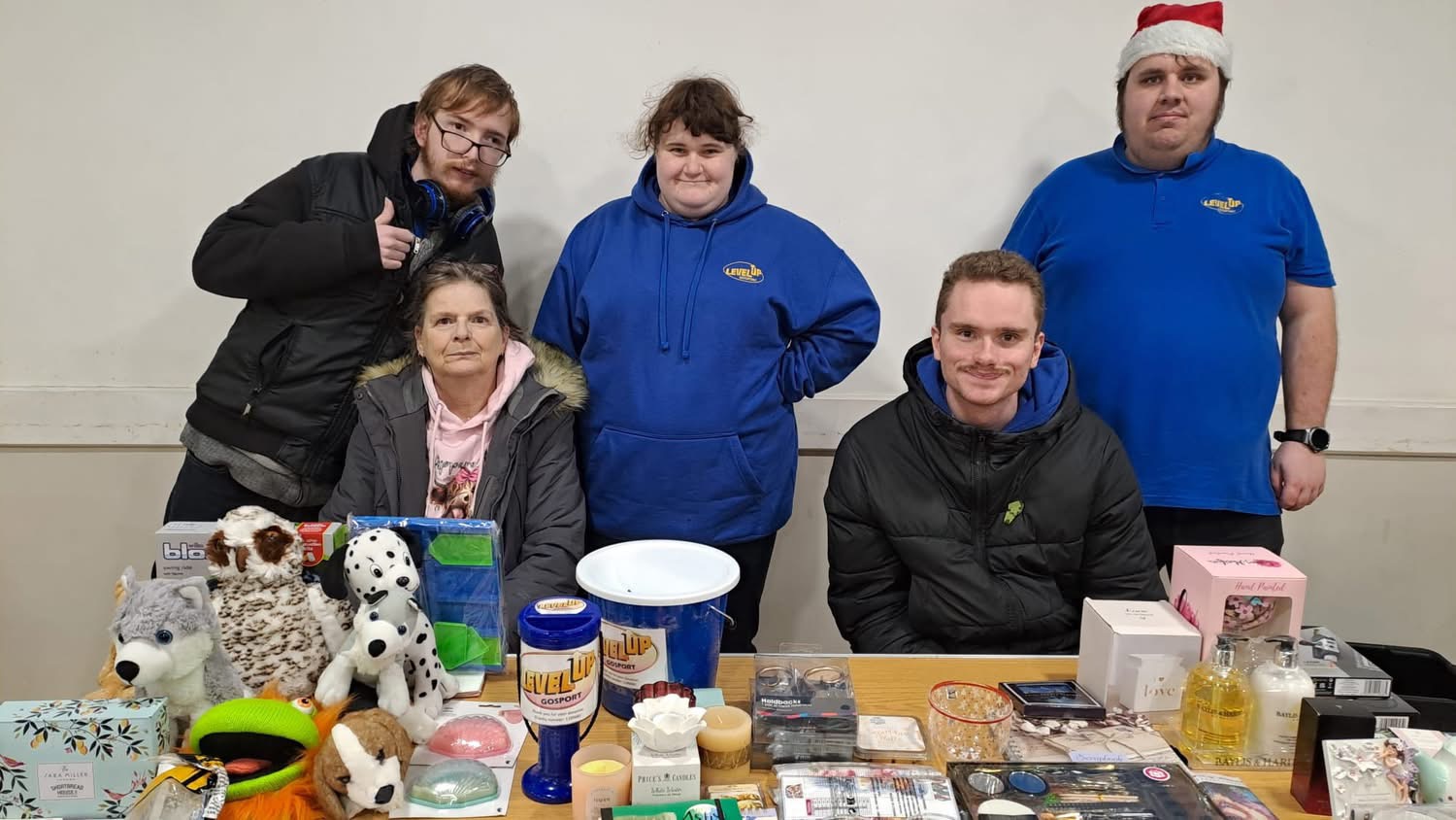 Collection of gifts to be given away with a donation basket